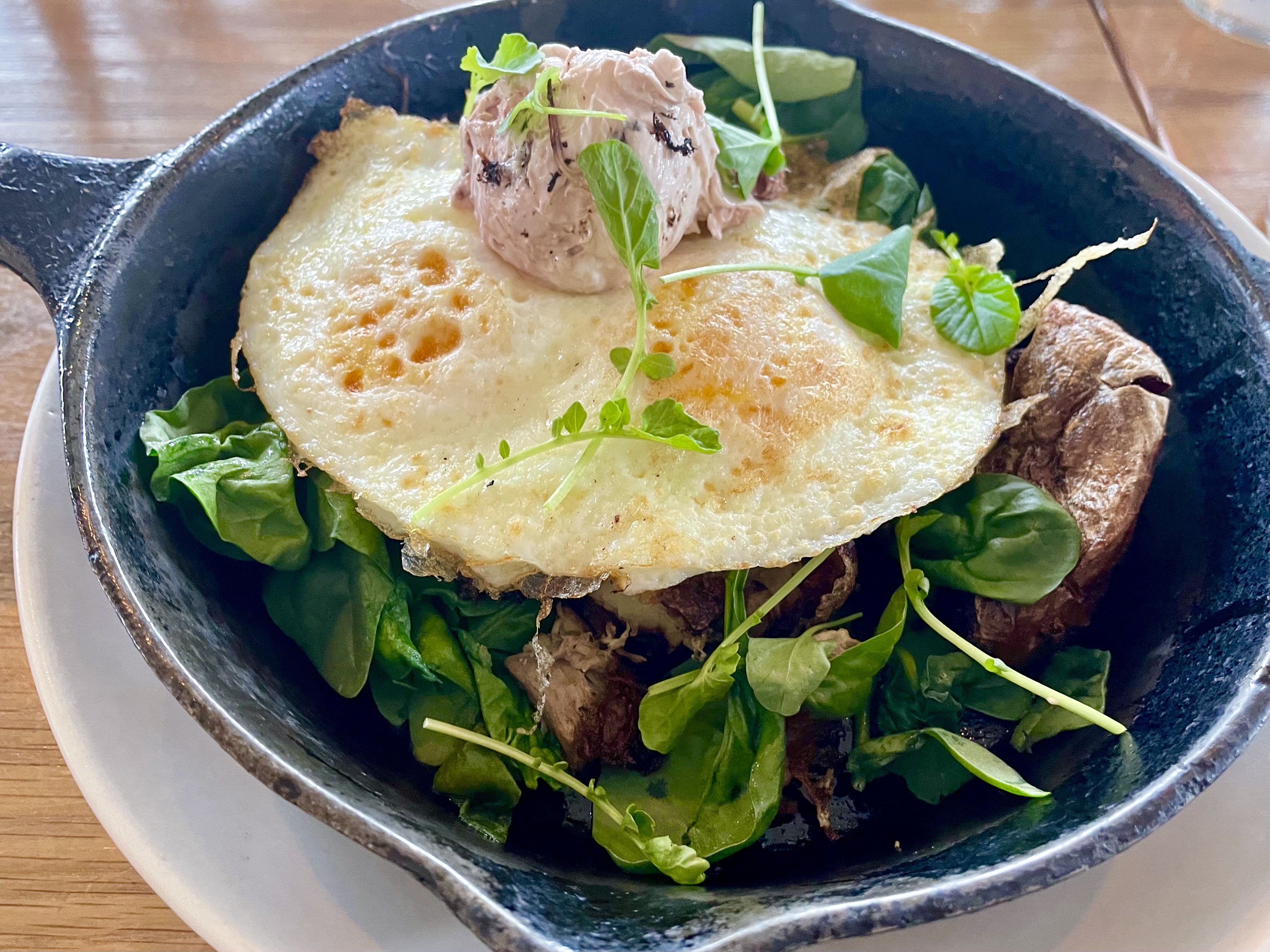 Cast Iron Duck Confit. Braised duck, spinach, potatoes, shallots, cabernet braised cherries, over easy eggs, cherry goat cheese mousse.
