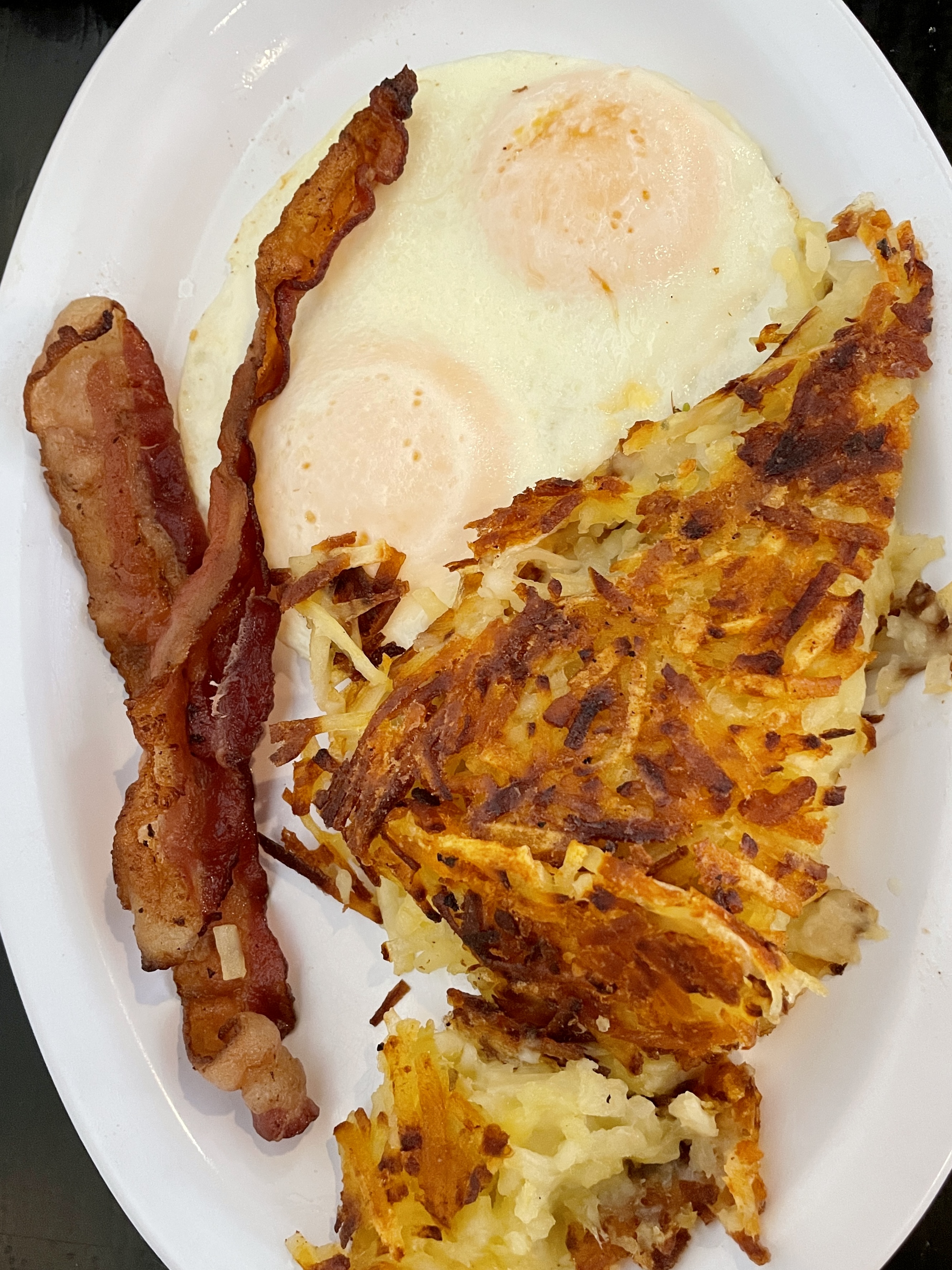 Ohana Special with two over easy eggs, bacon and hashbrowns