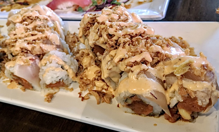 Two crunch rolls with spicy tuna, yellowtail, crunchy onions, and spicy mayo